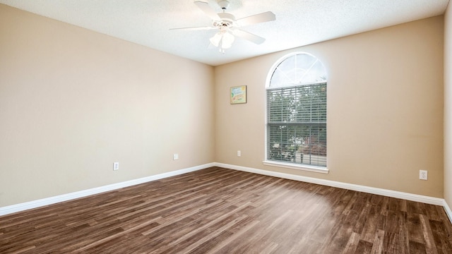 empty room with dark hardwood / wood-style floors, a textured ceiling, and ceiling fan