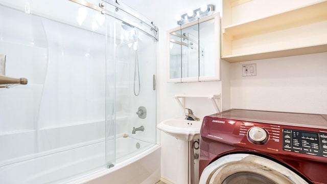 bathroom with washer / dryer and washtub / shower combination