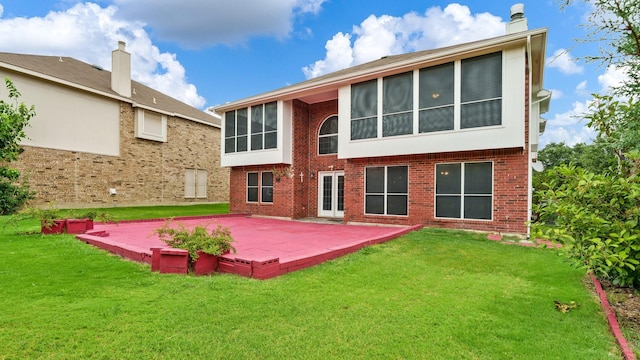 back of property with a patio and a lawn