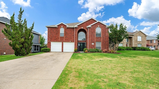 traditional-style home with a garage, brick siding, driveway, and a front yard