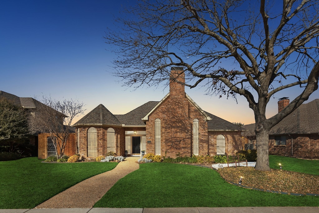 tudor home featuring a yard