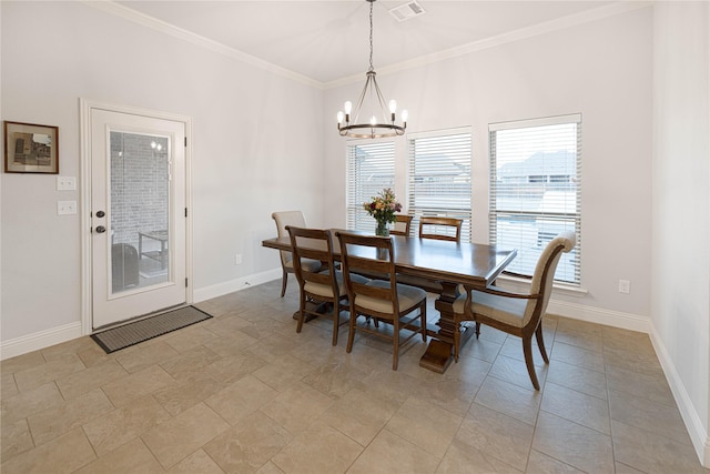 dining area featuring crown molding and a notable chandelier