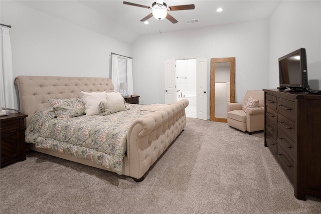 carpeted bedroom with ceiling fan, vaulted ceiling, and ensuite bathroom