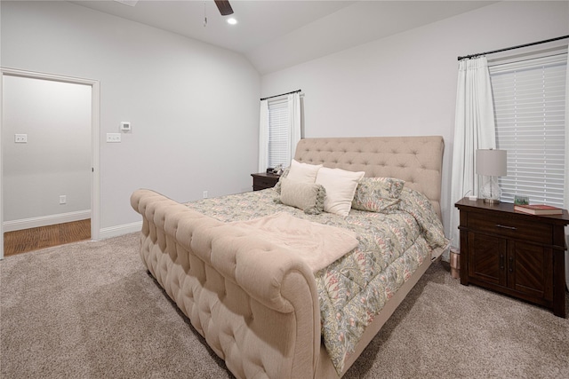 bedroom with light carpet, vaulted ceiling, and ceiling fan