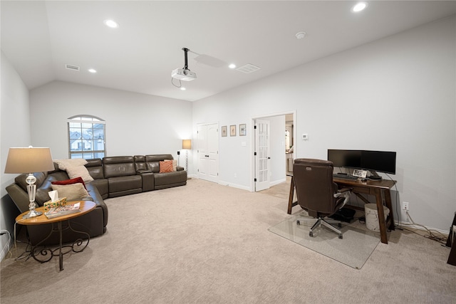 home office featuring light carpet and vaulted ceiling