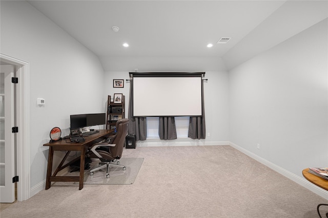 office area featuring light carpet and lofted ceiling