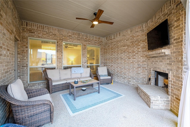 view of patio featuring ceiling fan and an outdoor living space with a fireplace