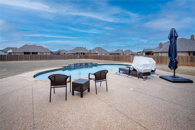 view of swimming pool featuring a patio and grilling area