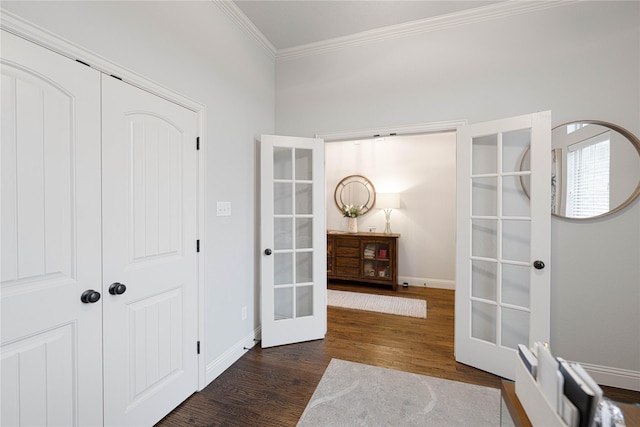 corridor featuring french doors, dark hardwood / wood-style floors, and ornamental molding