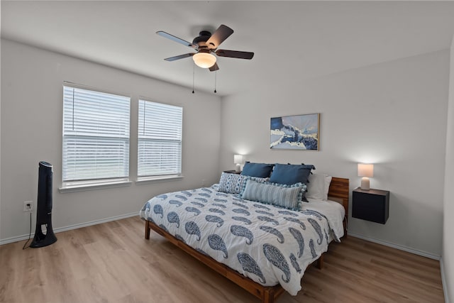 bedroom with ceiling fan and light wood-type flooring