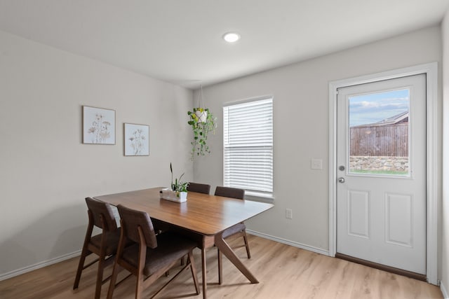 dining space featuring a healthy amount of sunlight and light hardwood / wood-style flooring