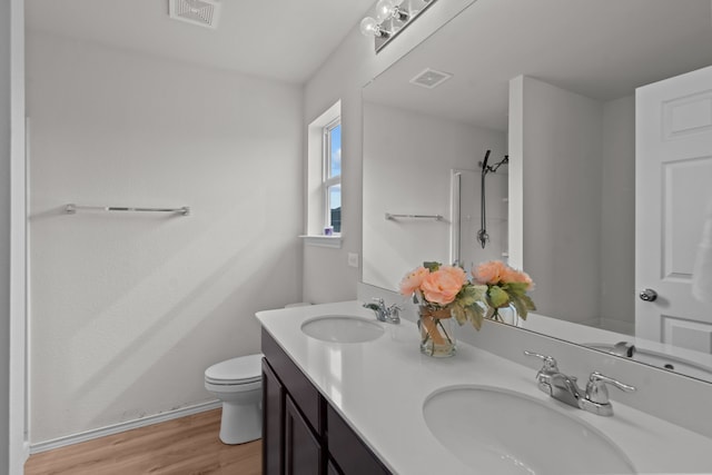 bathroom featuring hardwood / wood-style flooring, vanity, and toilet