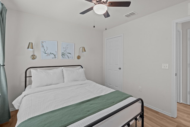 bedroom with ceiling fan and light hardwood / wood-style floors