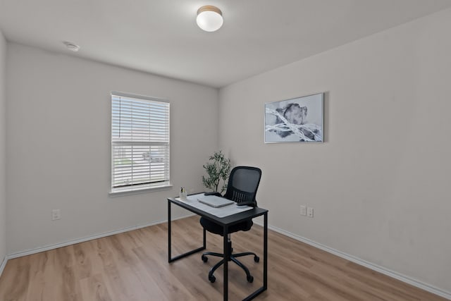 office with light hardwood / wood-style flooring