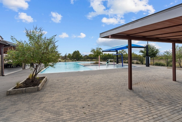 view of swimming pool with a patio