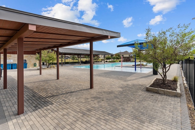 surrounding community with a swimming pool and a patio area