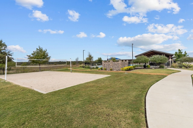 surrounding community with a lawn and volleyball court