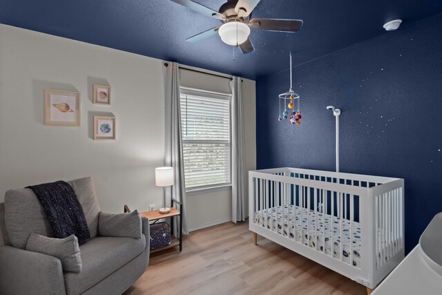 bedroom with ceiling fan and light wood-type flooring