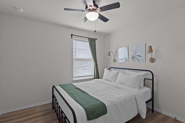 bedroom with ceiling fan and dark hardwood / wood-style flooring