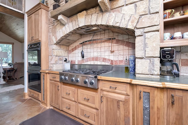 kitchen featuring lofted ceiling, wooden ceiling, double oven, stainless steel gas stovetop, and tile patterned flooring