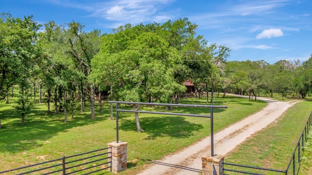 surrounding community featuring a lawn and a rural view