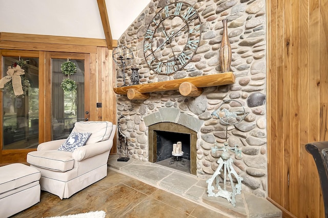 unfurnished room featuring a stone fireplace, high vaulted ceiling, beamed ceiling, and tile patterned floors