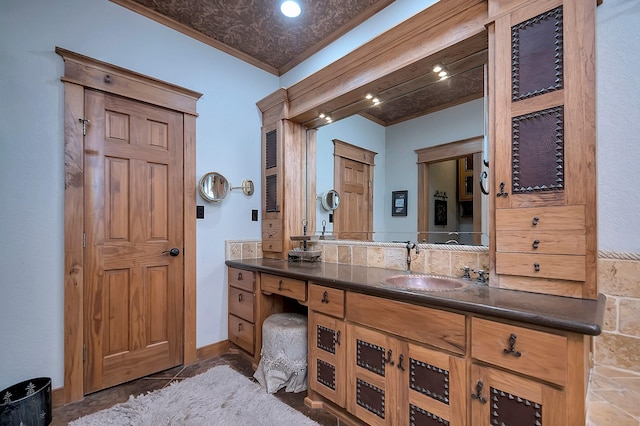 bathroom featuring ornamental molding and vanity