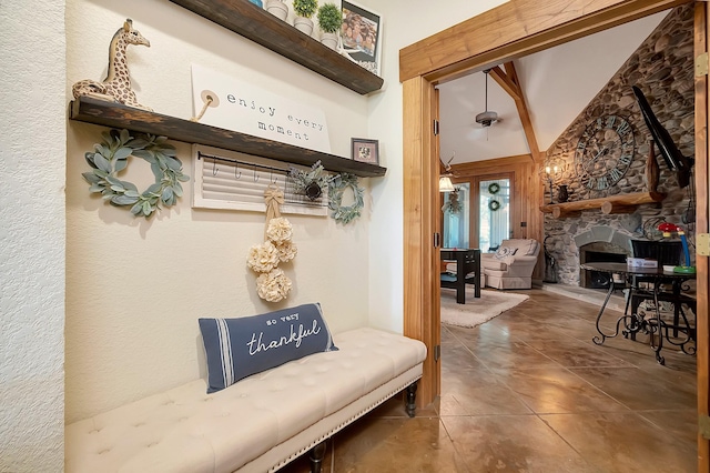 interior space featuring tile patterned flooring, a towering ceiling, and a fireplace