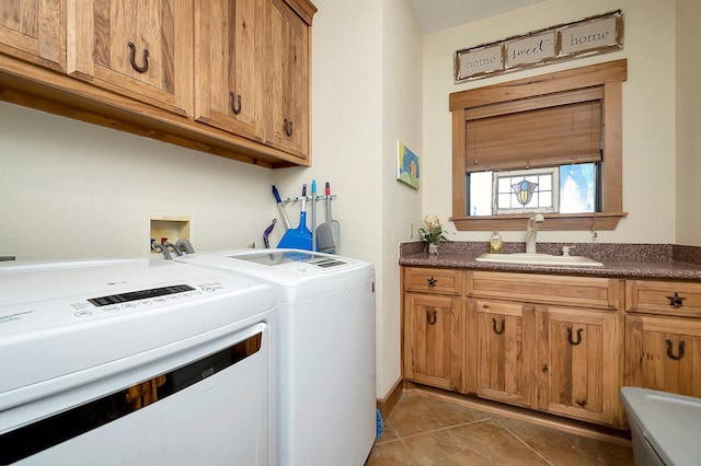 laundry area featuring sink, tile patterned floors, cabinets, and independent washer and dryer