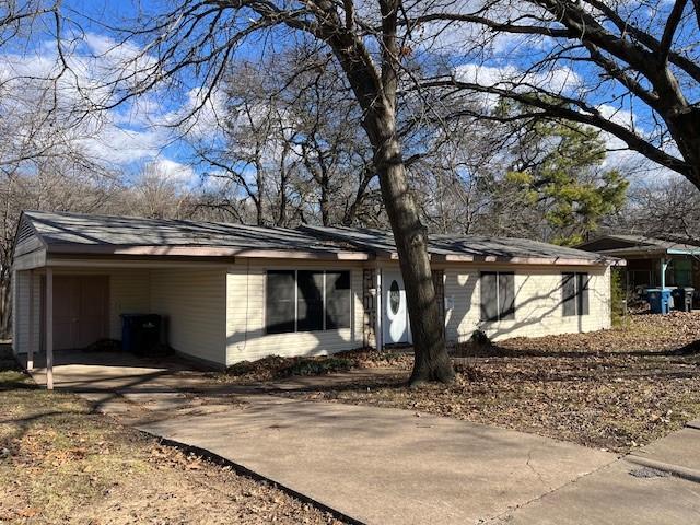 view of front facade featuring a carport and a garage