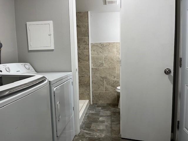 laundry room featuring electric panel and washing machine and dryer