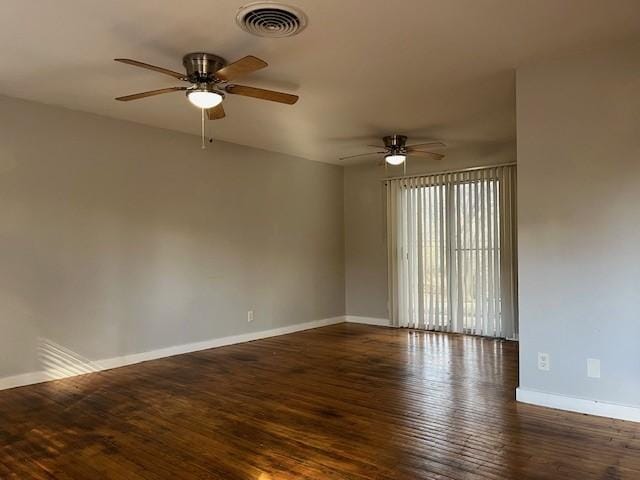 spare room featuring dark hardwood / wood-style floors and ceiling fan