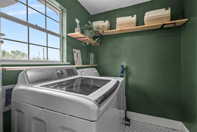 washroom with washer and clothes dryer and tile patterned floors