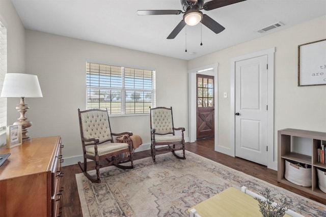 sitting room featuring dark hardwood / wood-style floors and ceiling fan