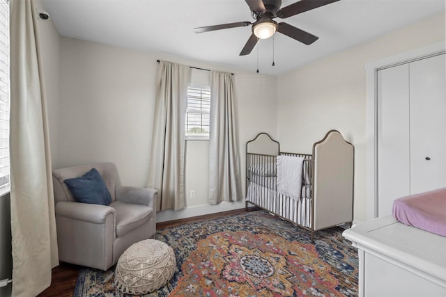 bedroom featuring dark hardwood / wood-style floors, ceiling fan, and a closet