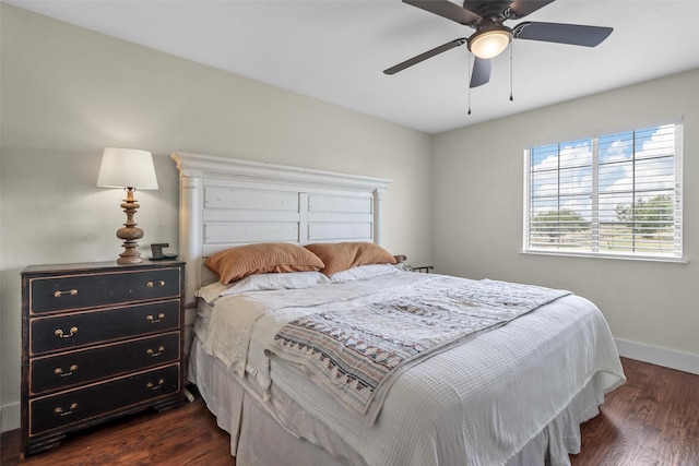 bedroom with dark hardwood / wood-style floors and ceiling fan