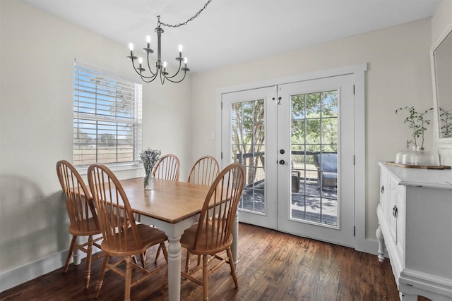 dining room with an inviting chandelier, a wealth of natural light, dark hardwood / wood-style flooring, and french doors