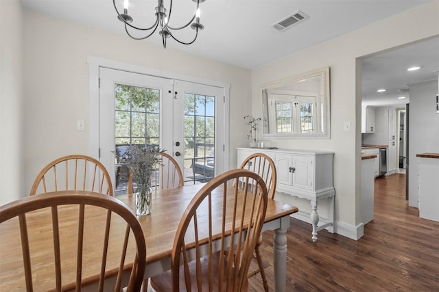 dining area with an inviting chandelier, dark hardwood / wood-style floors, and french doors