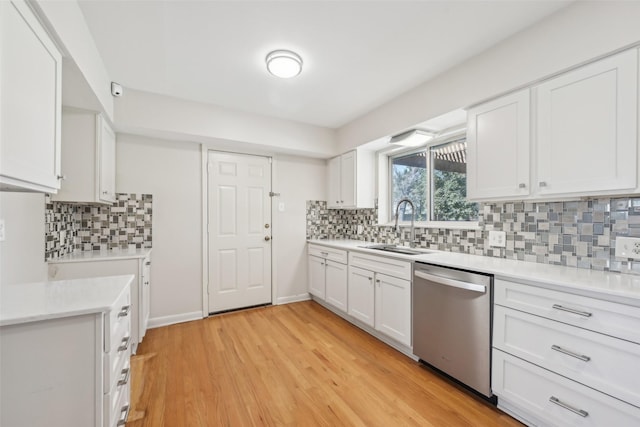 kitchen featuring white cabinets, sink, dishwasher, and light wood-type flooring