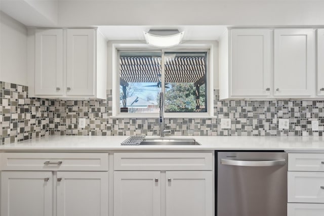 kitchen with white cabinetry, sink, decorative backsplash, and dishwasher