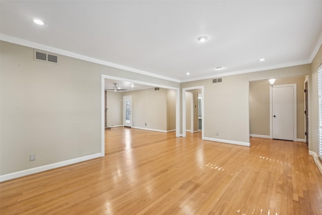 spare room with crown molding, ceiling fan, and light wood-type flooring