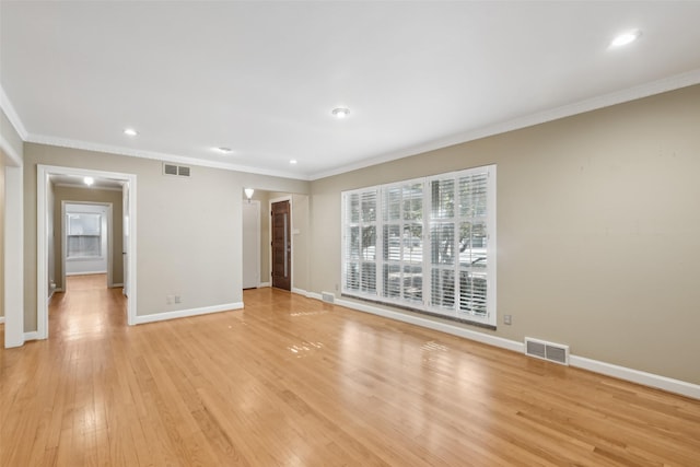 interior space featuring crown molding and light hardwood / wood-style floors