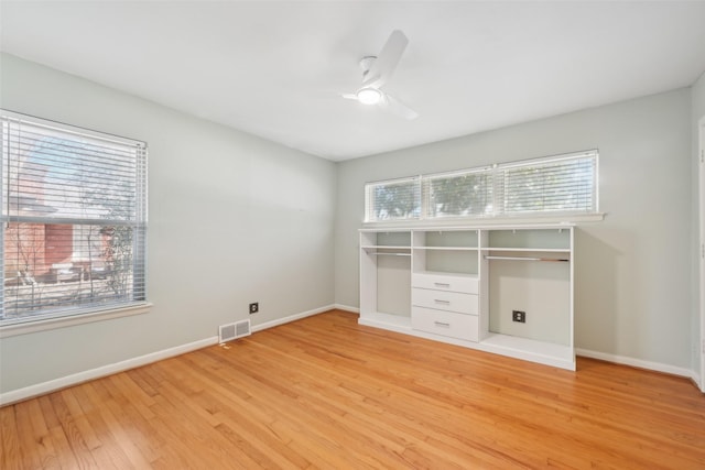 unfurnished bedroom featuring light hardwood / wood-style floors, ceiling fan, and a closet