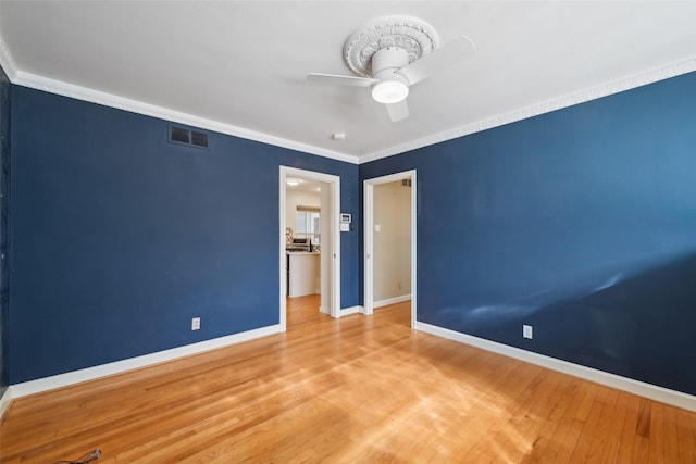 unfurnished bedroom with ornamental molding, hardwood / wood-style floors, and ceiling fan