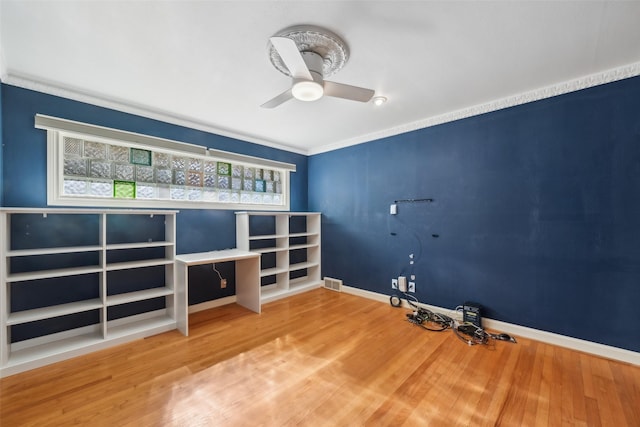 interior space featuring ceiling fan, ornamental molding, and hardwood / wood-style floors