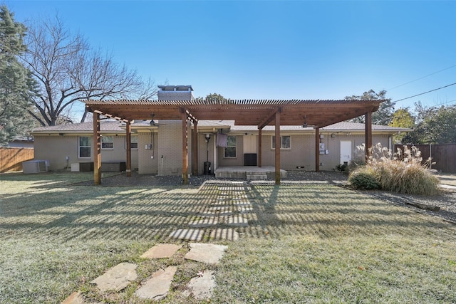 rear view of house with central AC, a yard, and a pergola