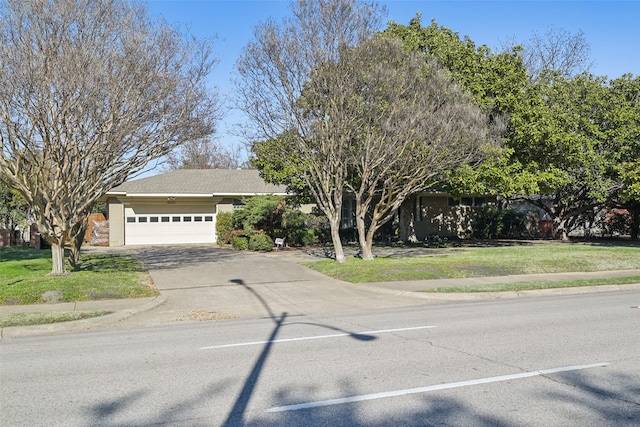 view of front of property with a garage and a front lawn