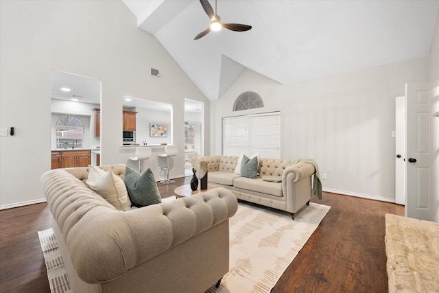 living room featuring a ceiling fan, visible vents, wood finished floors, high vaulted ceiling, and baseboards