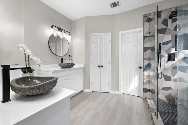 bathroom featuring vanity and a shower with shower door