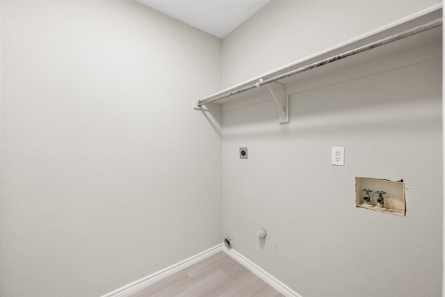 washroom with gas dryer hookup, hardwood / wood-style floors, hookup for a washing machine, and hookup for an electric dryer